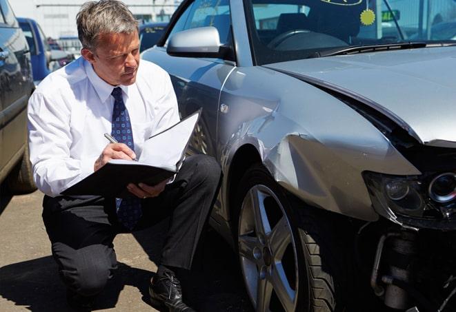 woman signing paperwork for auto insurance